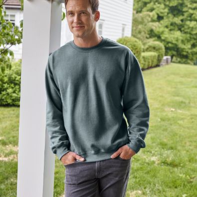 man wearing Gildan sweatshirt leaning by pole